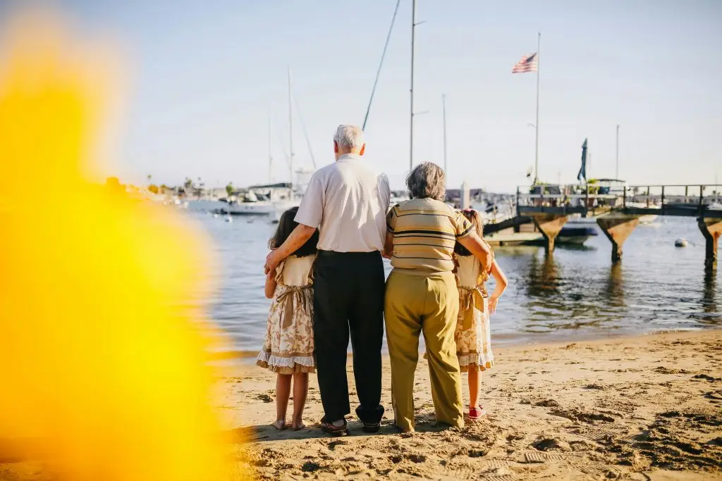 Family enjoying a sunset at the beach, symbolizing the peaceful moments in life.
