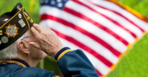 Veteran saluting American flag with pride